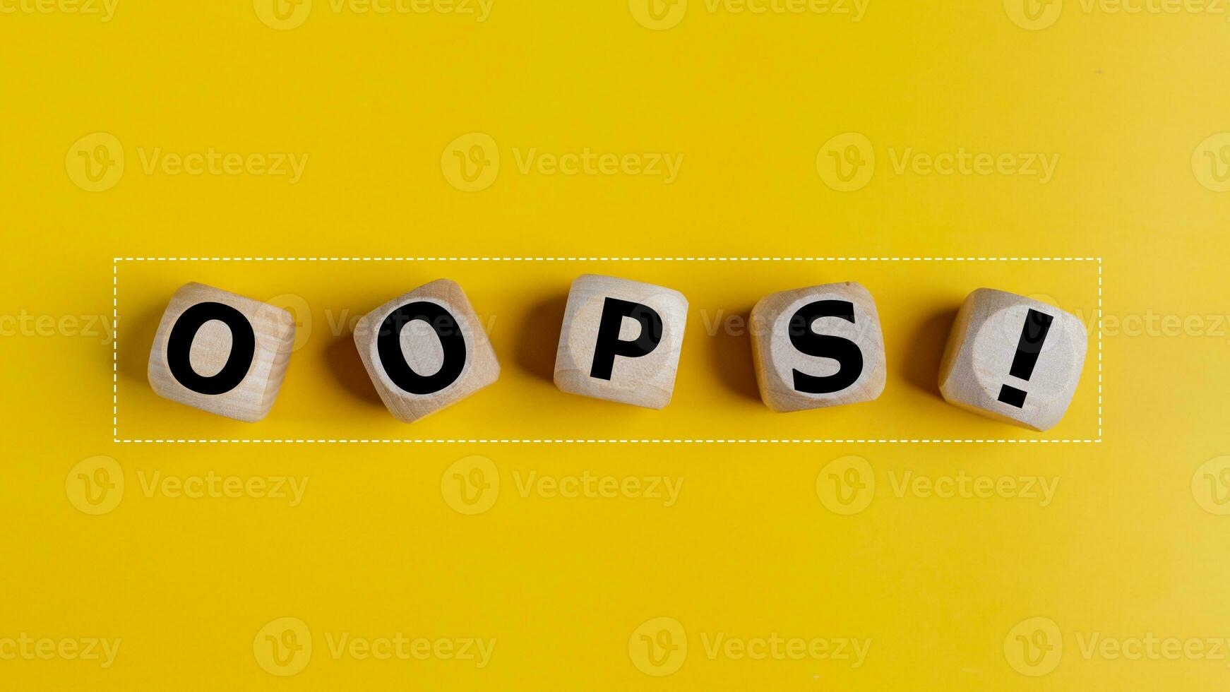 The wooden cubes with the word oops on a yellow background. Apologies for any mistake or error photo
