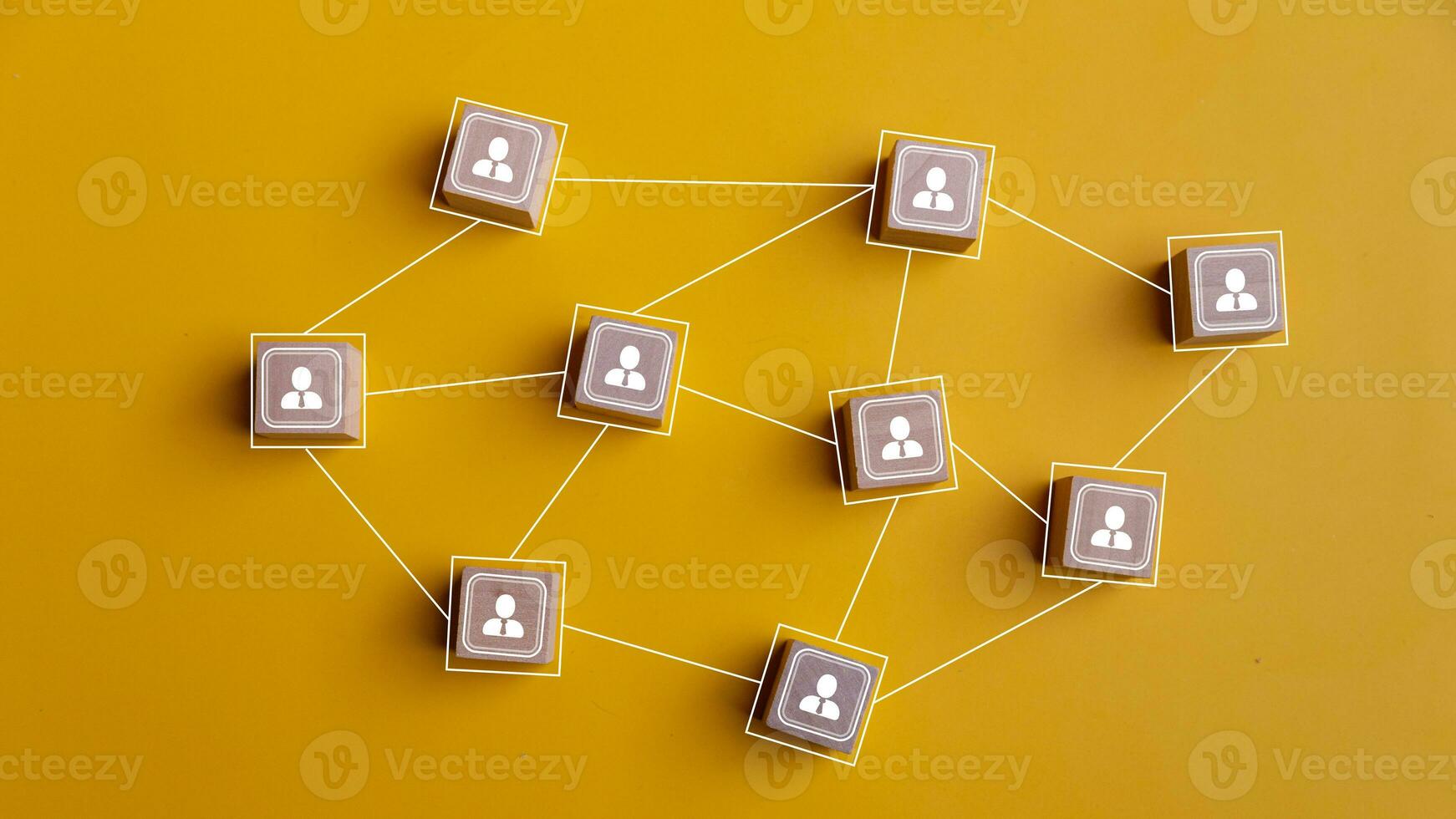 Wooden blocks connected together on a yellow background. Teamwork, network, and community concept. photo