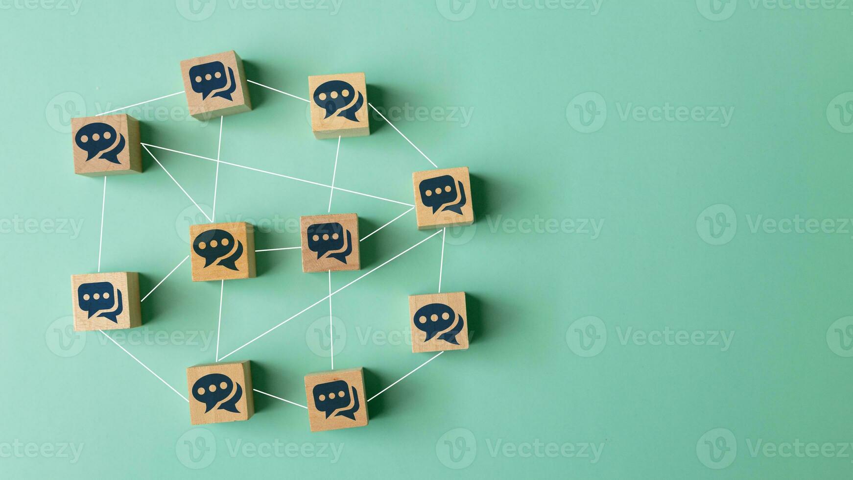 Concept of online communication or social networking. Wooden cubes with speech bubbles linked to each other with lines. photo