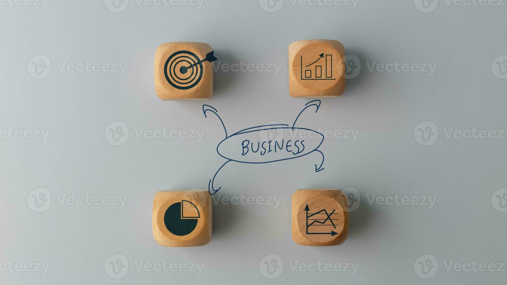 Business plan idea sketches with business icons on wooden cubes over a grey background. Business planning concept photo