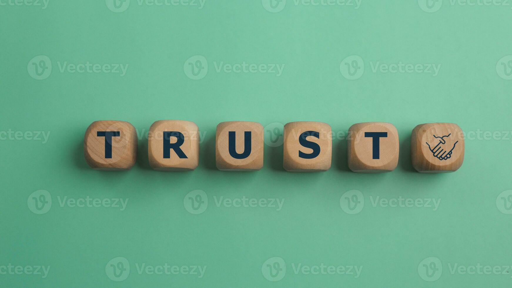 Wooden blocks with the word Trust. Trust relationships between business partners, friends, and relatives. Respect and authority. Confidence in a person. Reliable partner photo