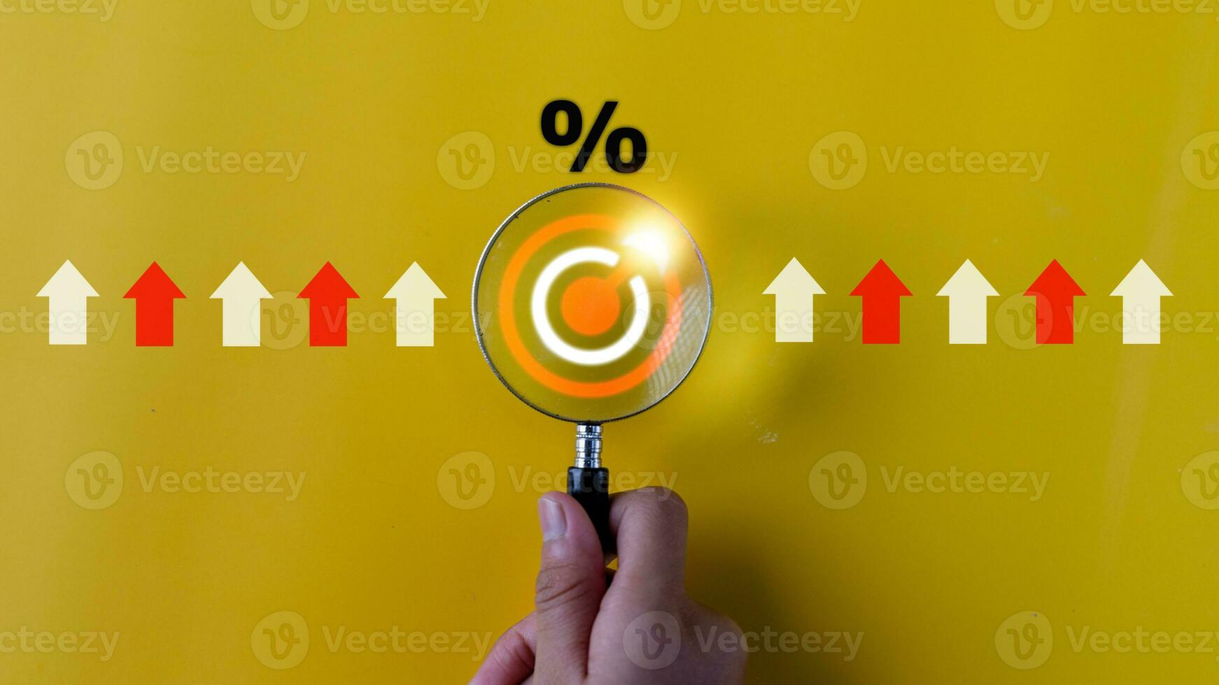 Magnifying glass with percentage symbol and up arrow, Interest rates continue to increase, return on stocks and mutual funds, long term investment for retirement. Interest rate and dividend concept. photo