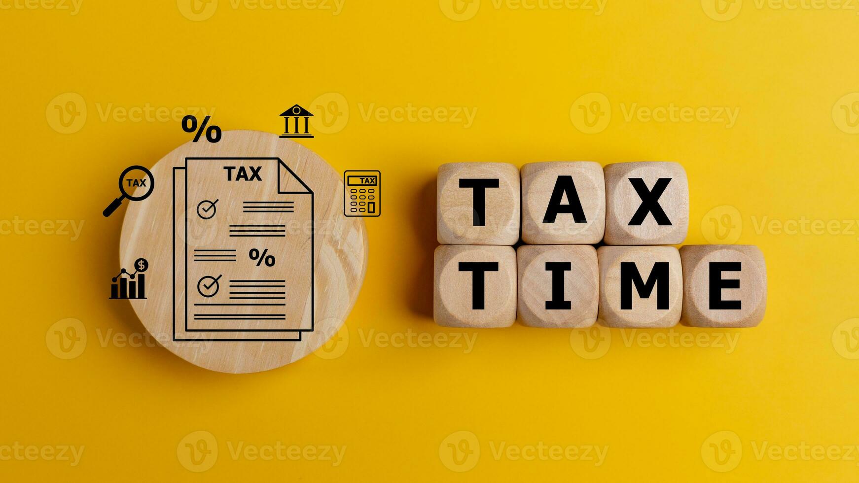 Tax time concept with text on wooden cubes on a yellow background. Tax payment reminder or annual taxation concept. photo