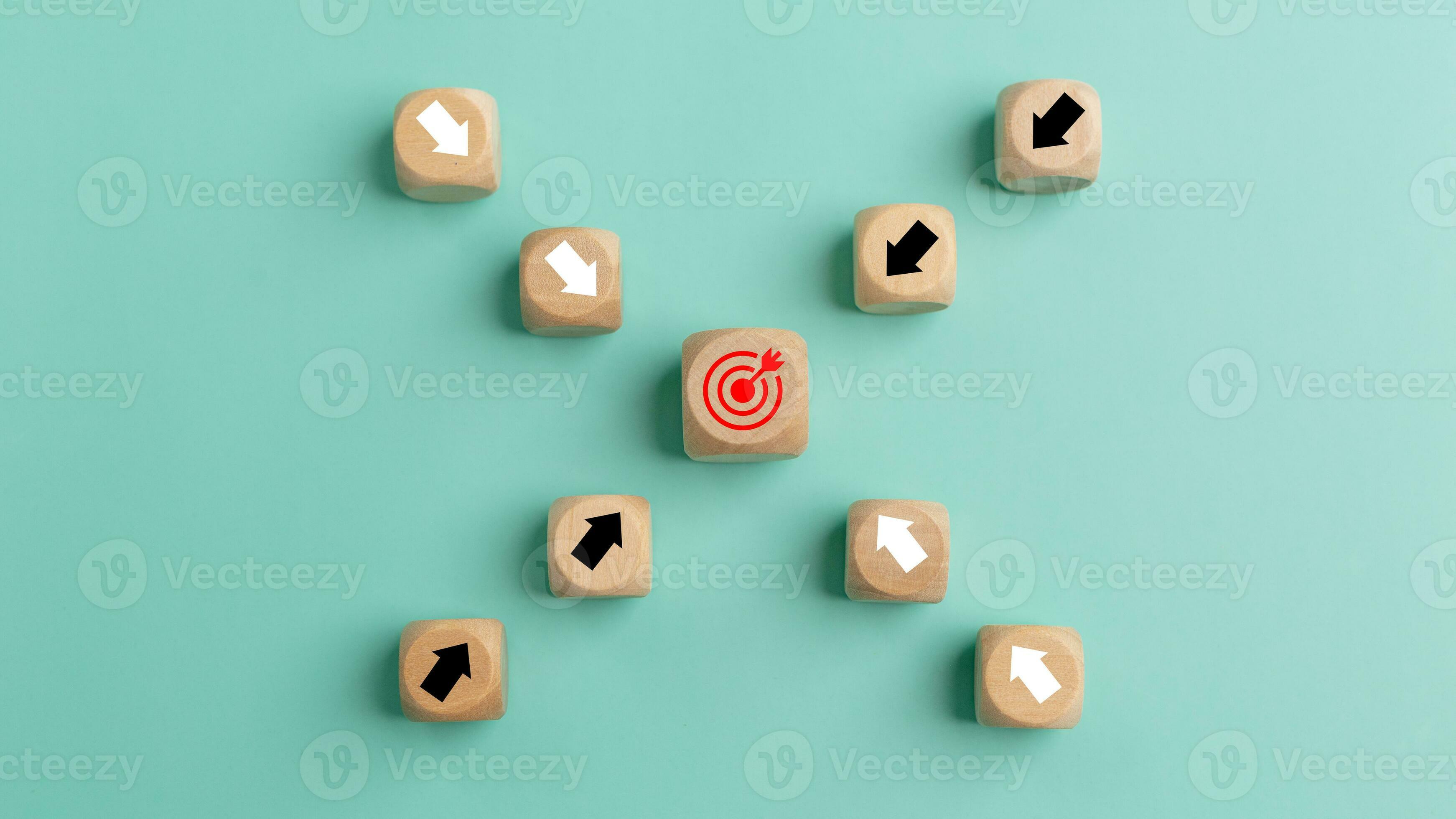 Wooden blocks with arrow and target on green background. Success