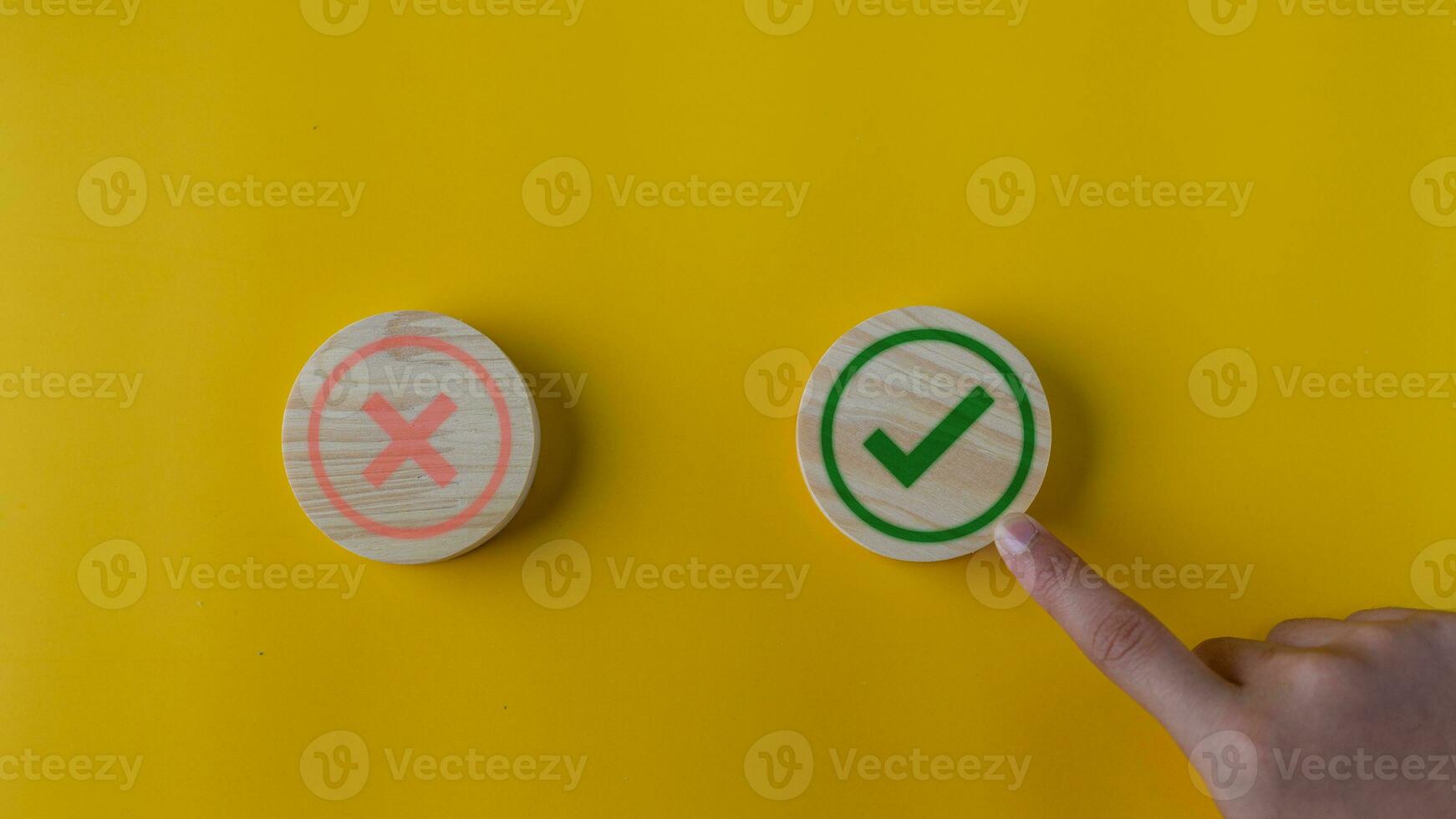 Right and wrong or voting yes or no concept. Wooden blocks with check marks on a yellow background. The idea of choice. photo