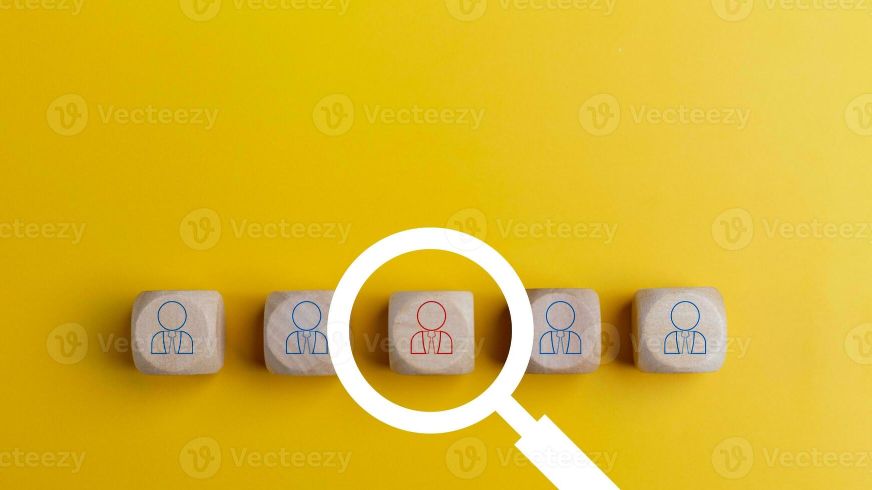 Searching for a new job concept. Magnifying glass and wooden cube with people icons. Online recruitment application specialist search service concept photo