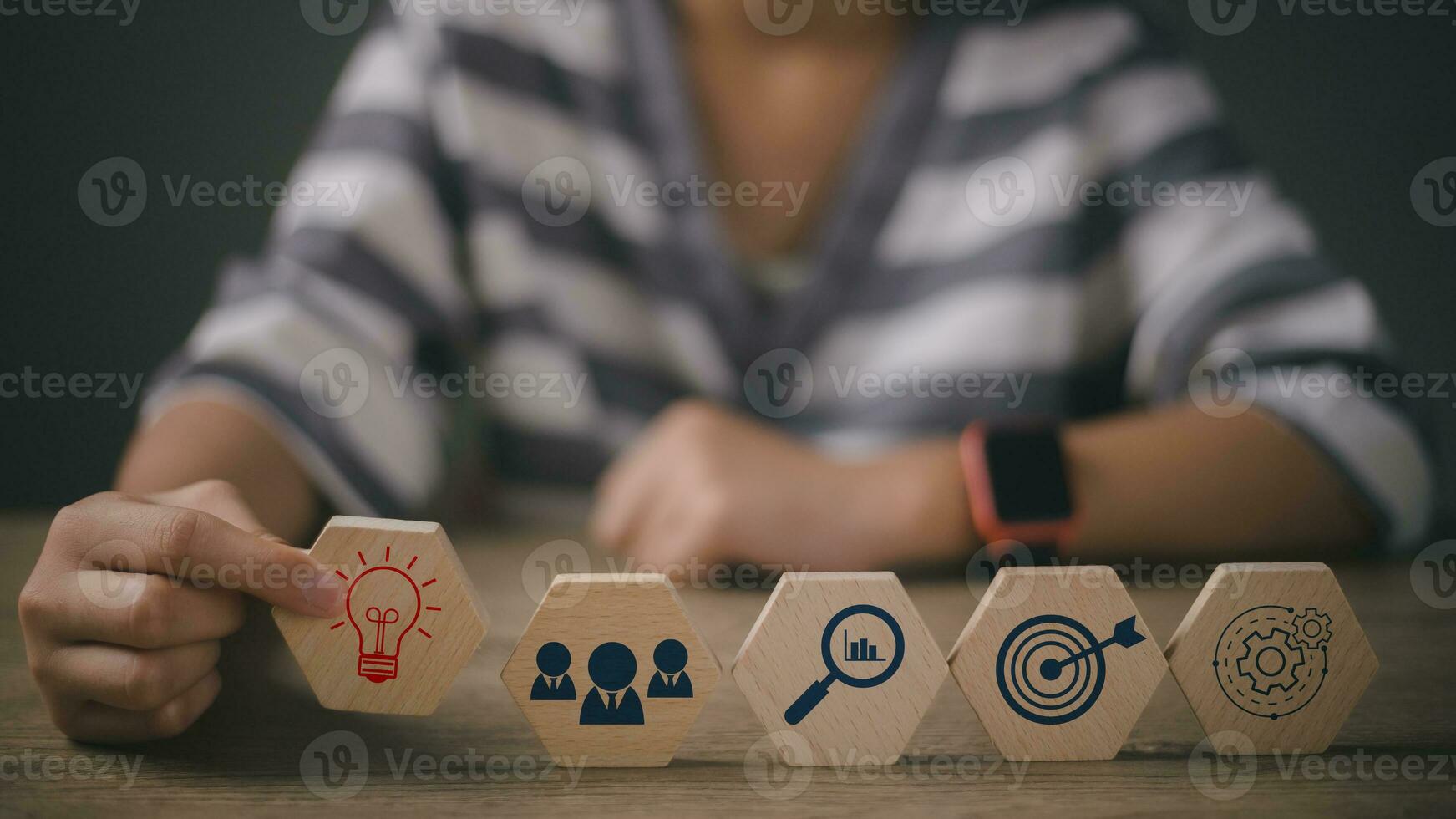 Woman hand holding lightbulb above dartboard, Gear, and magnifying icon block. thinking, business planning process, goal, strategy, target, mission, action, research, teamwork and idea concept photo