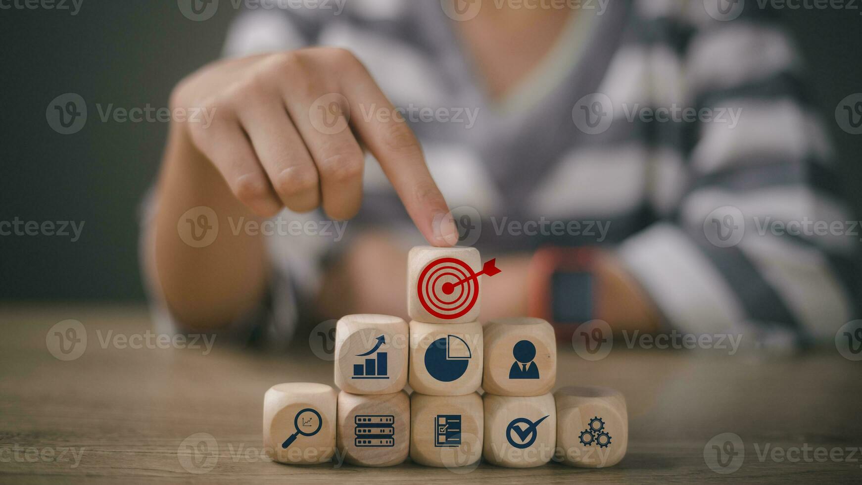 Women touching woods block cube with icon target and company strategy development, Concept success, and business goals. photo