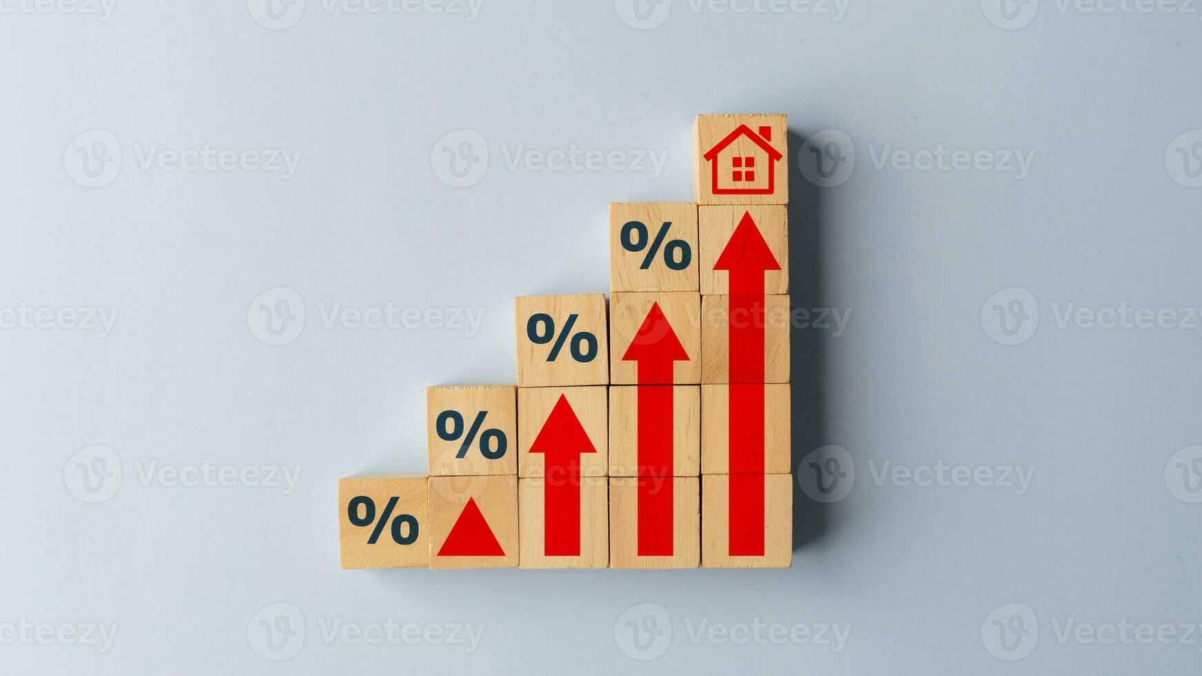 House icon on wooden cube from stack block with percent and rise arrow. Real estate property investment concept. Asset management, Interest rates, inflation, loan mortgage, increase tax. photo