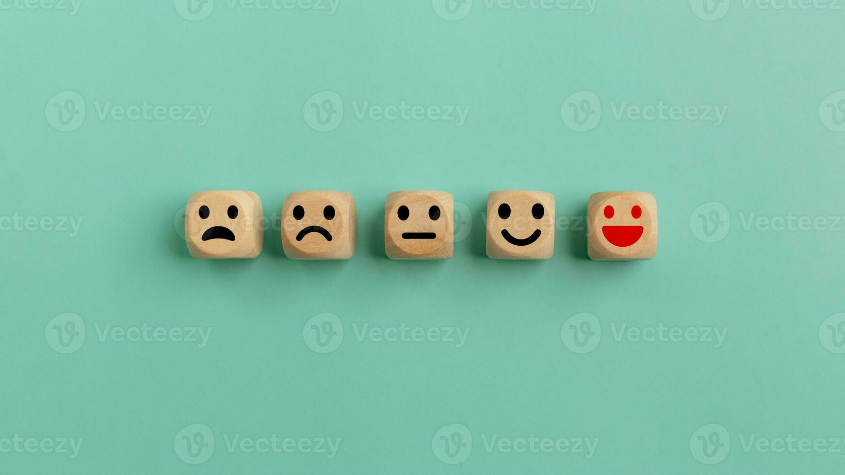 Customer feedback rating positive review, Human health and wellness check. World Mental Health Day, Think Positive and Satisfaction survey concept. Wooden cubes with emotion icons. photo