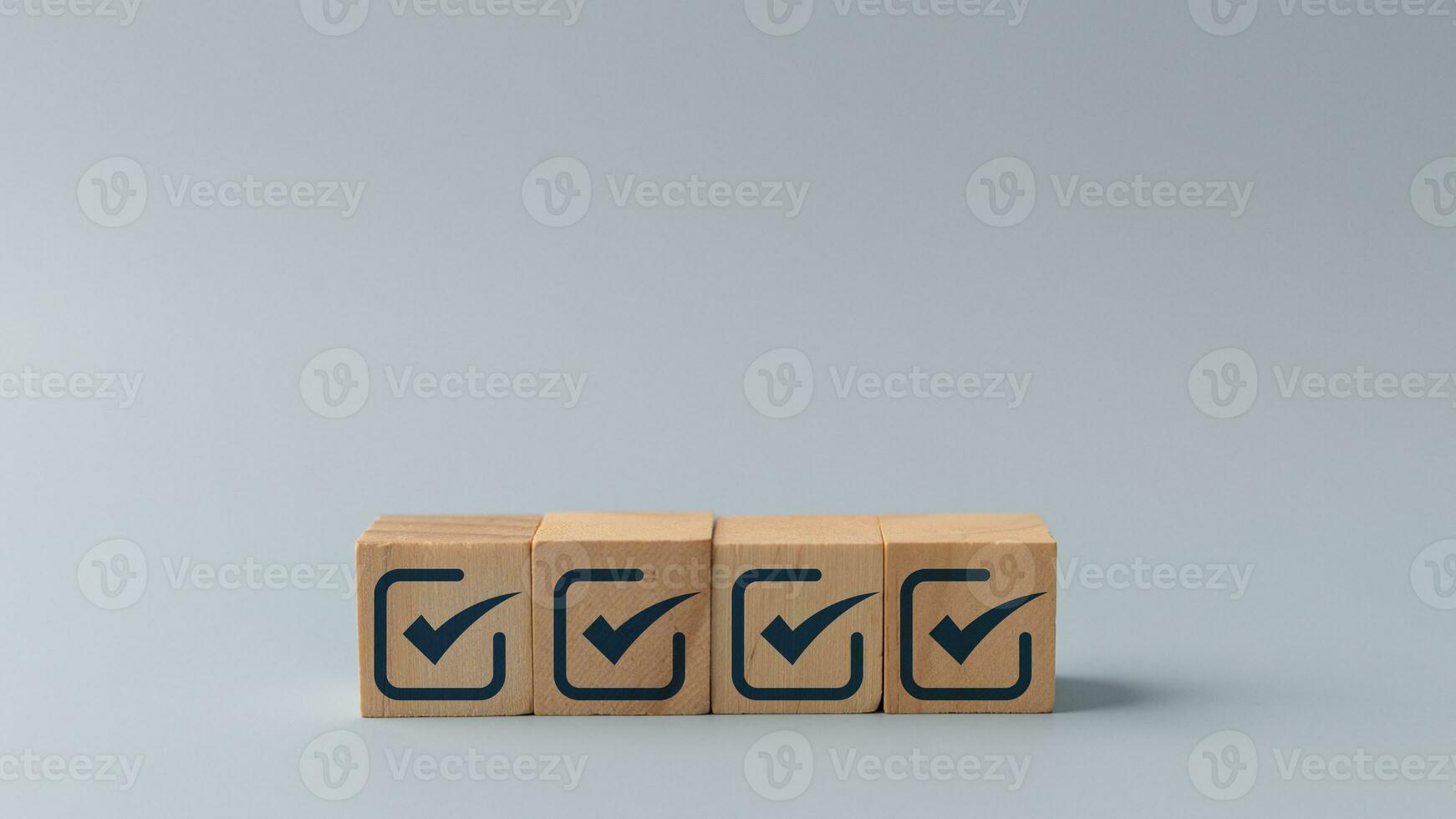 Checklist, Check mark icons for the jobs list on the wooden blocks. Task lists, Surveys, Assessments, Lists, Confirm items, Quality Control. Goals achievement business success. photo