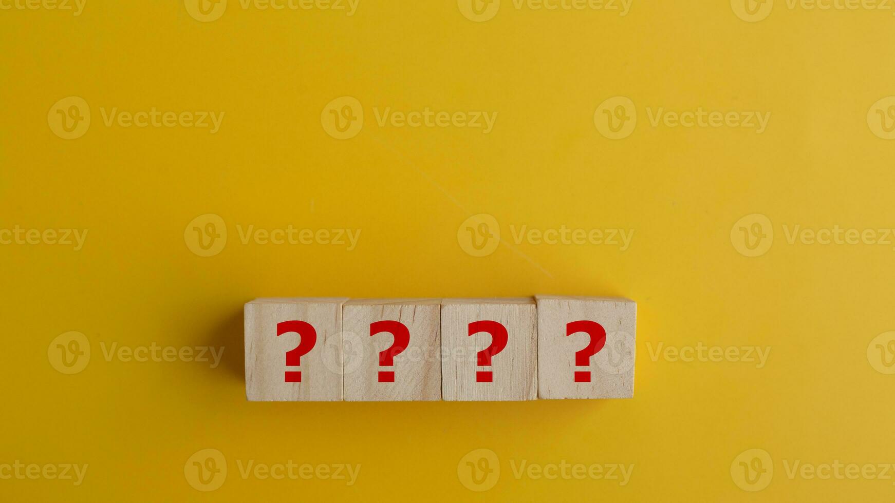 Wooden cube with Question Marks symbol with copy space used for Question and Answer, Information, FAQ concept. photo