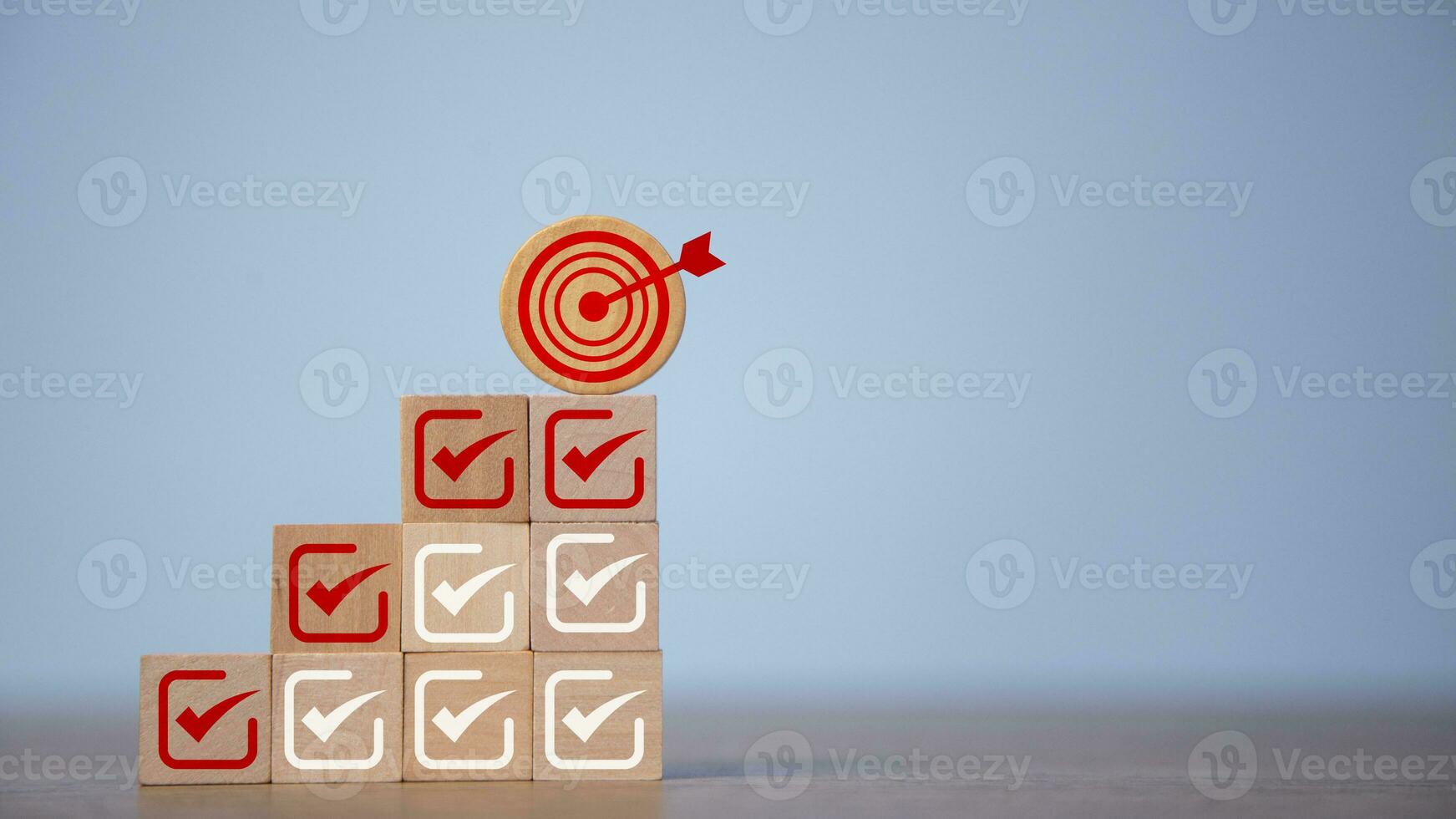 Check mark and dartboard from top of wooden cube stacks. Keys for success in business. Checklist, Complete Task list. Goals achievement or enterprise objective target for company success. To do list. photo