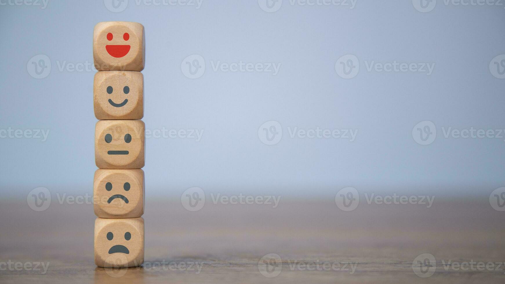 Customer feedback rating positive or negative review, Human health and wellness check. World mental health day, Think Positive and Satisfaction survey concept. Wooden cubes stacked with emotion icons. photo