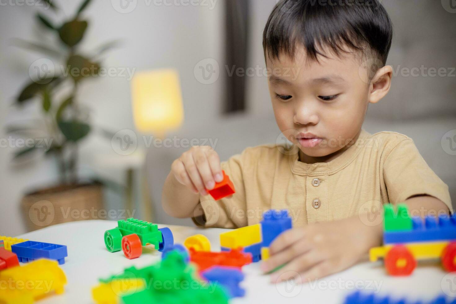 The Kid Playing With Colorful Toy Blocks Little Boy Building The Car the-kid-playing-with-colorful-toy-blocks-little-boy-building-the-car