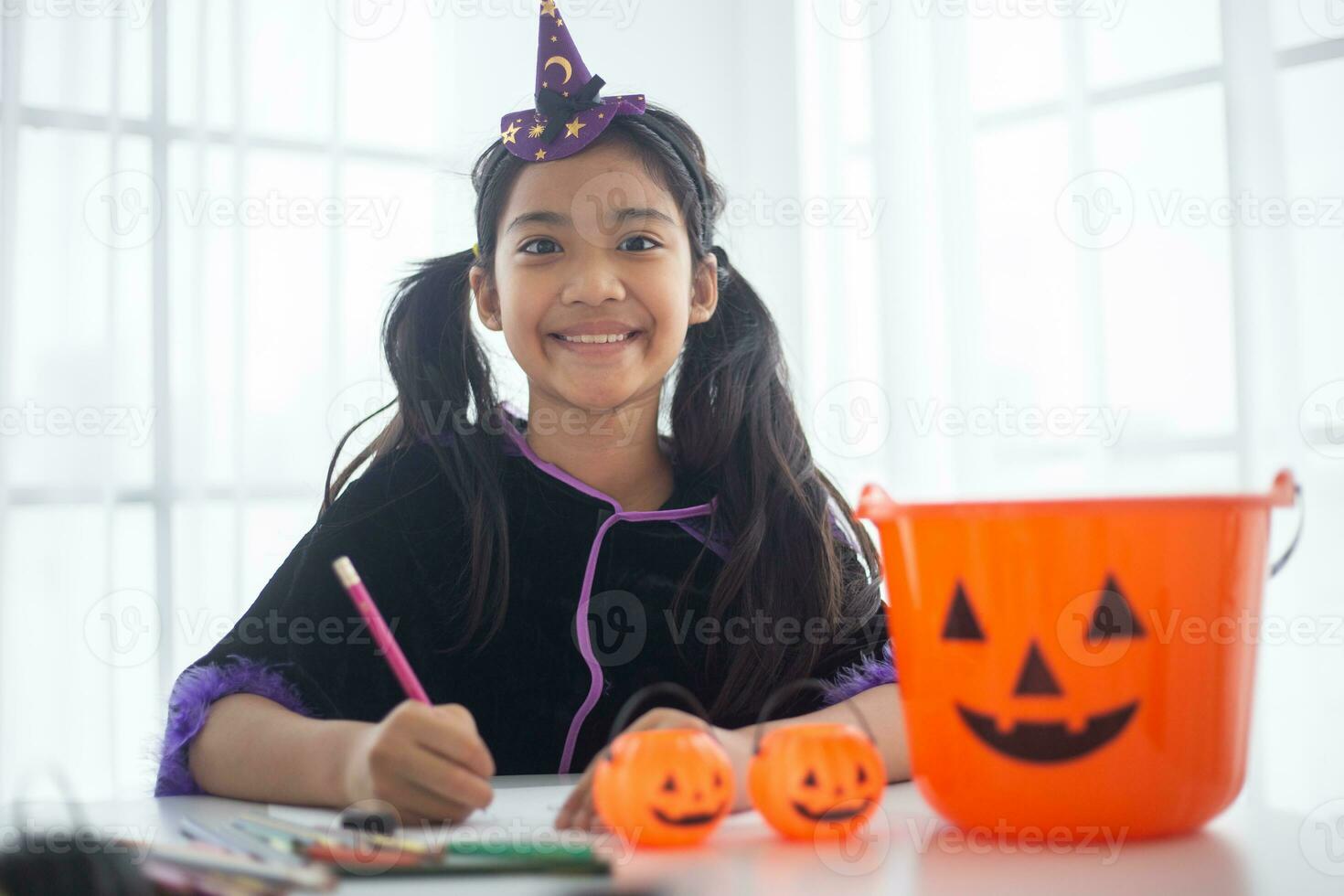 Happy Asian child girl in a witch costume to Halloween. trick or treat. Kids trick or treating. photo