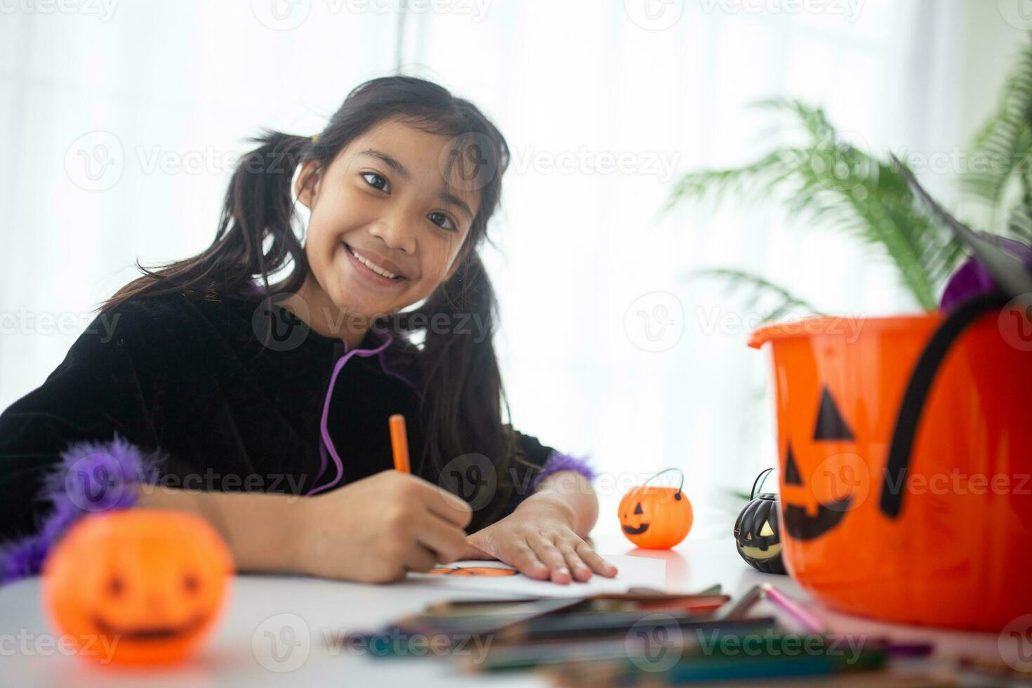 Happy Asian child girl in a witch costume to Halloween. trick or treat. Kids trick or treating. photo