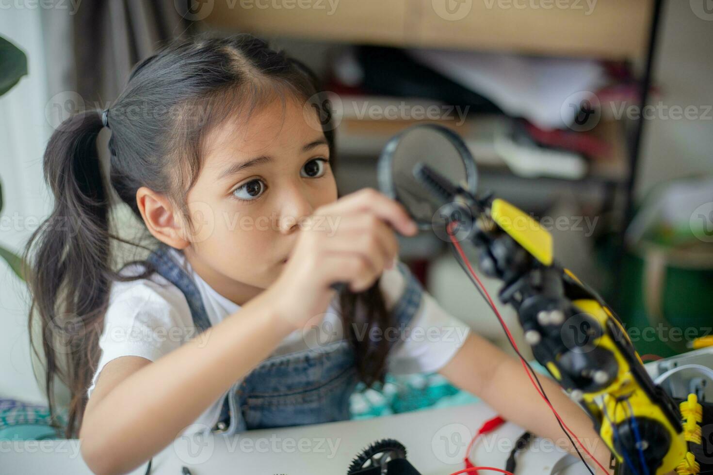 STEM education concept. Asian young girl learning robot design. photo