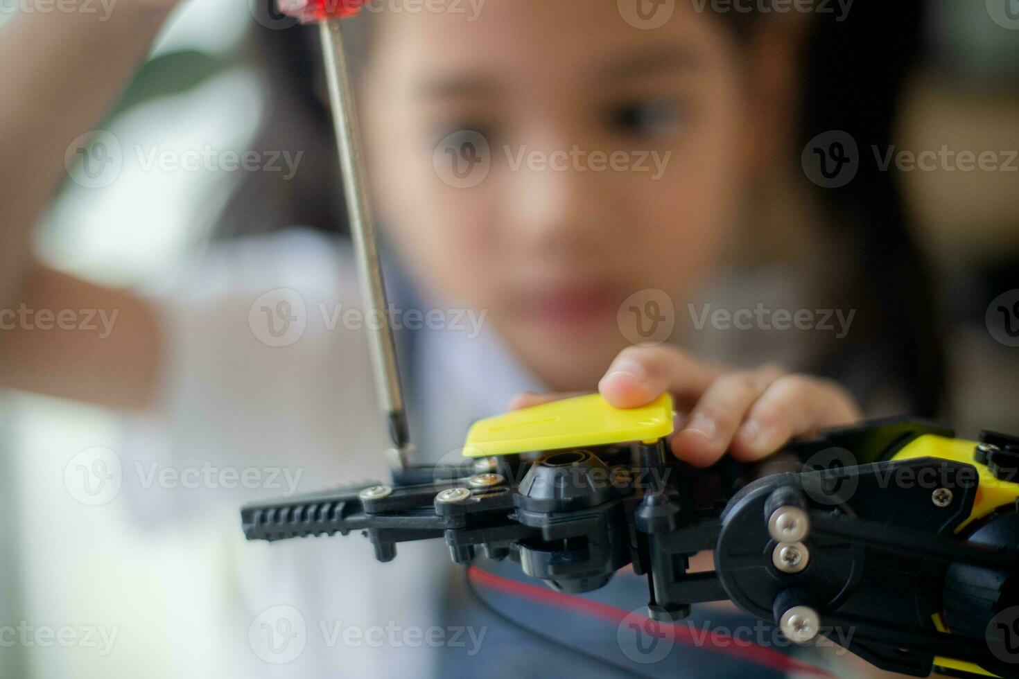 STEM education concept. Asian young girl learning robot design. photo