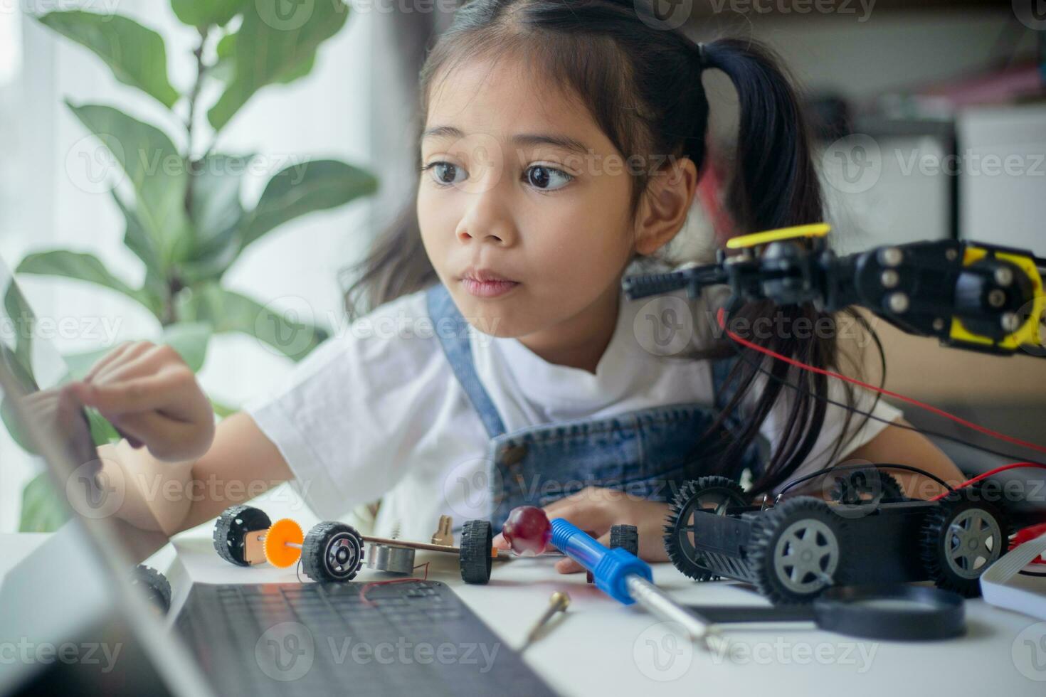 STEM education concept. Asian young girl learning robot design. photo