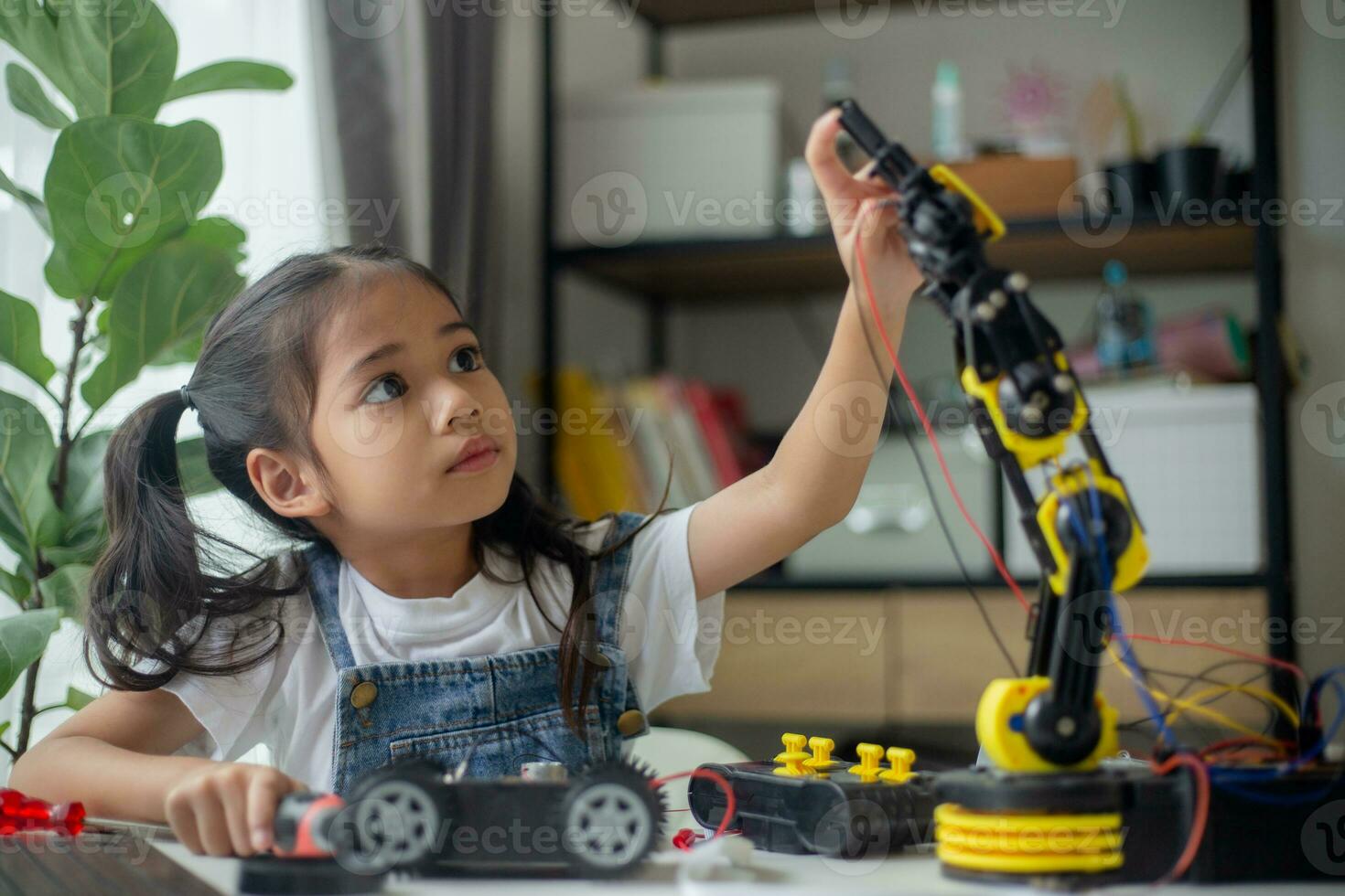 STEM education concept. Asian young girl learning robot design. photo