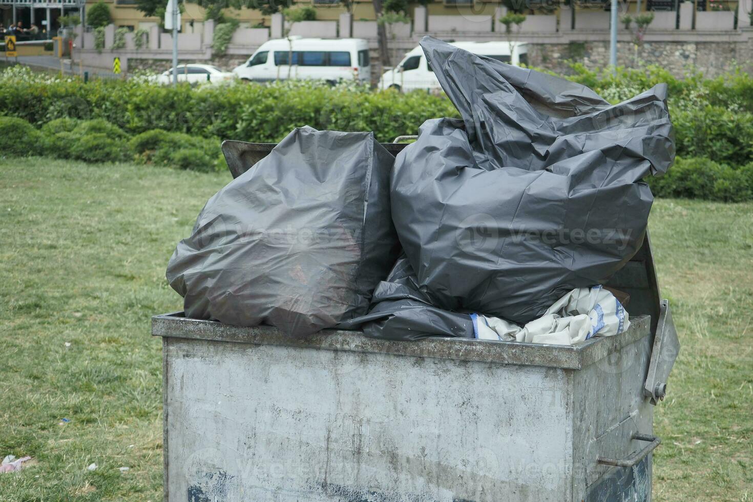 Bag with garbage and rubbish bin photo