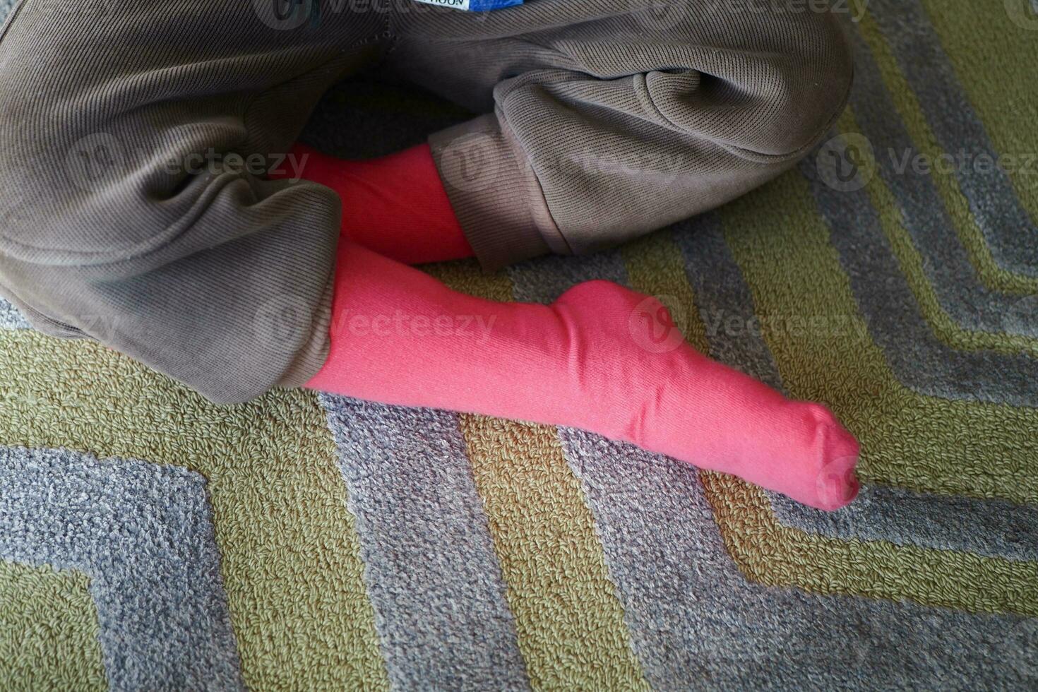 a colorful soft socks on child feet . photo