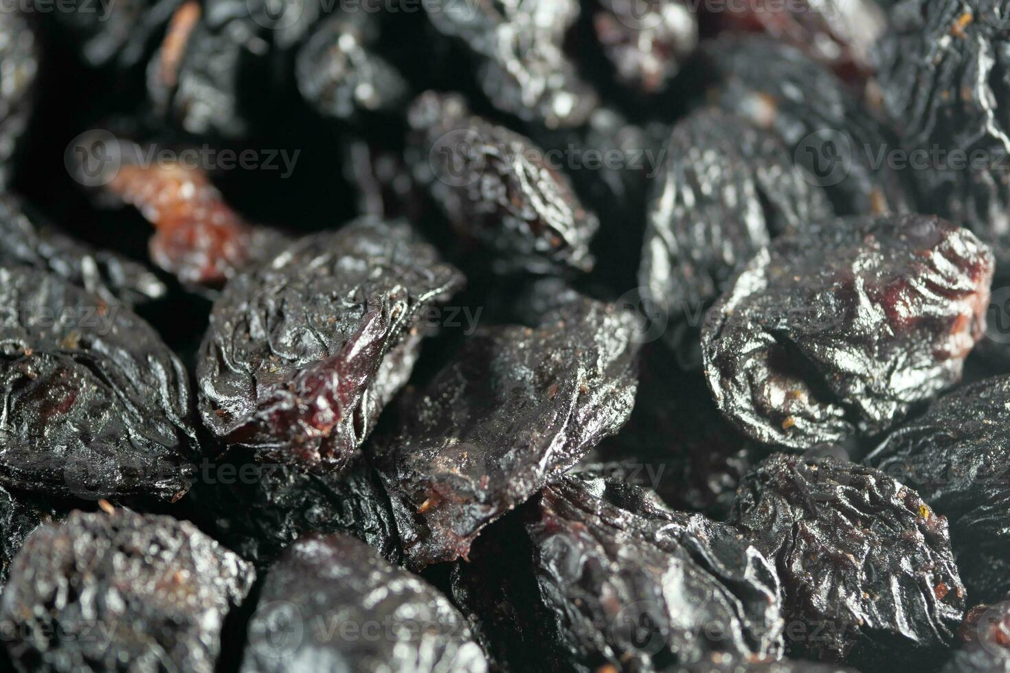 black raisin on white background, close up, photo