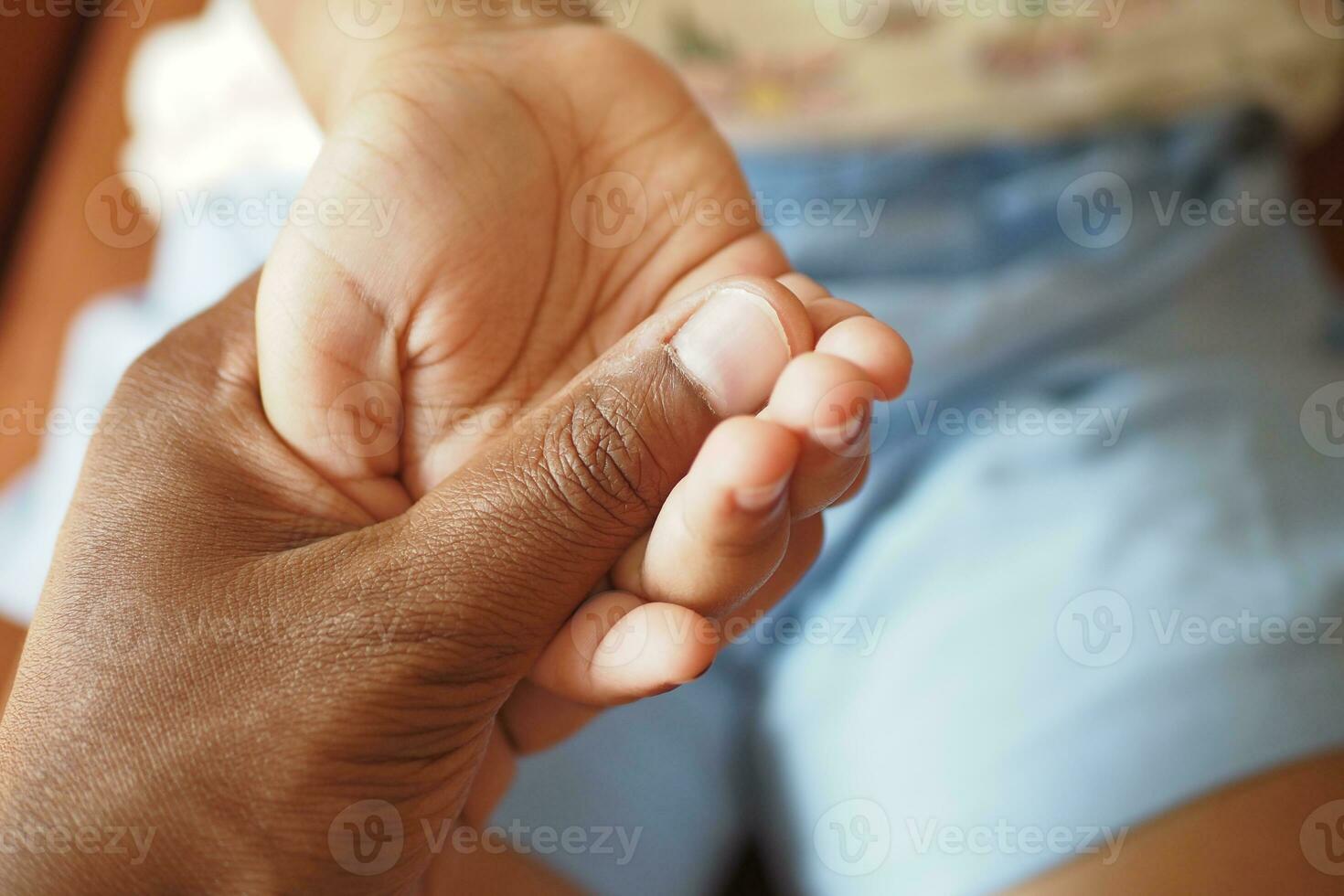 father holding hand of baby child, close up . photo