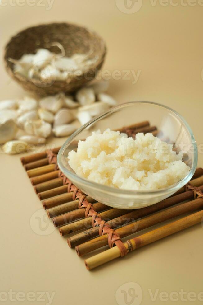 close up of minced garlic on a wooden spoon photo