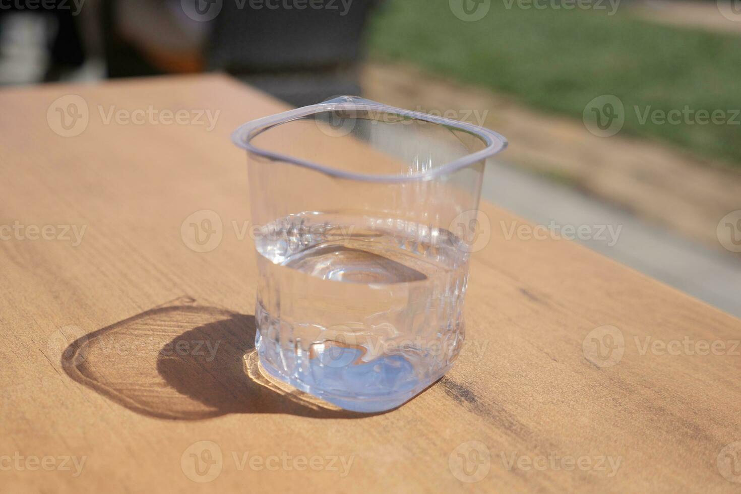 fresh drinking water in a plastic container on table photo