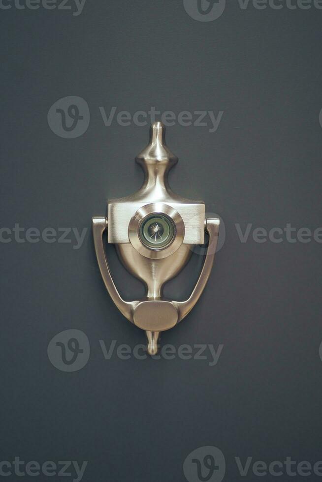 Classic brass door knocker on a wood background photo