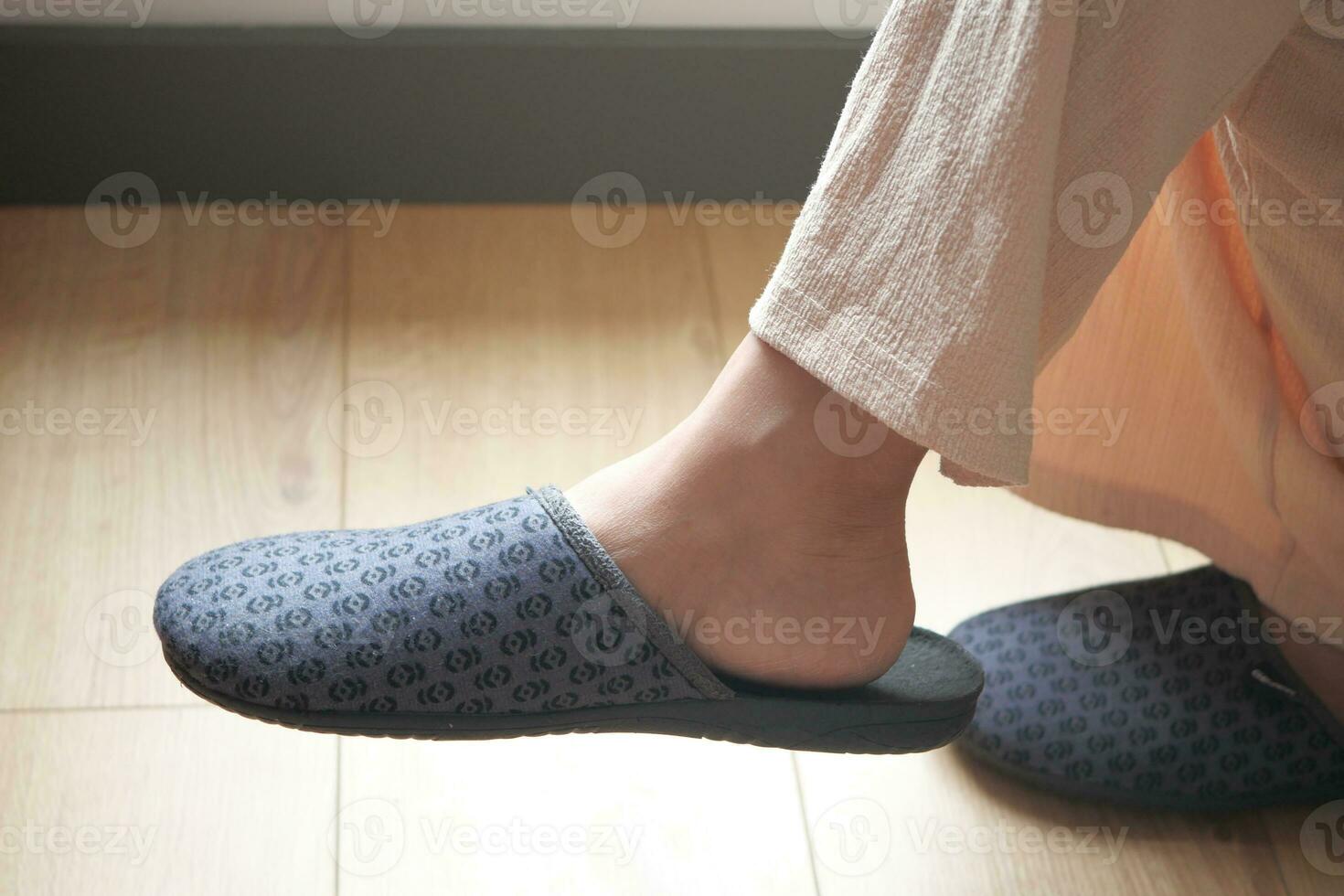 Woman in soft slippers at home photo