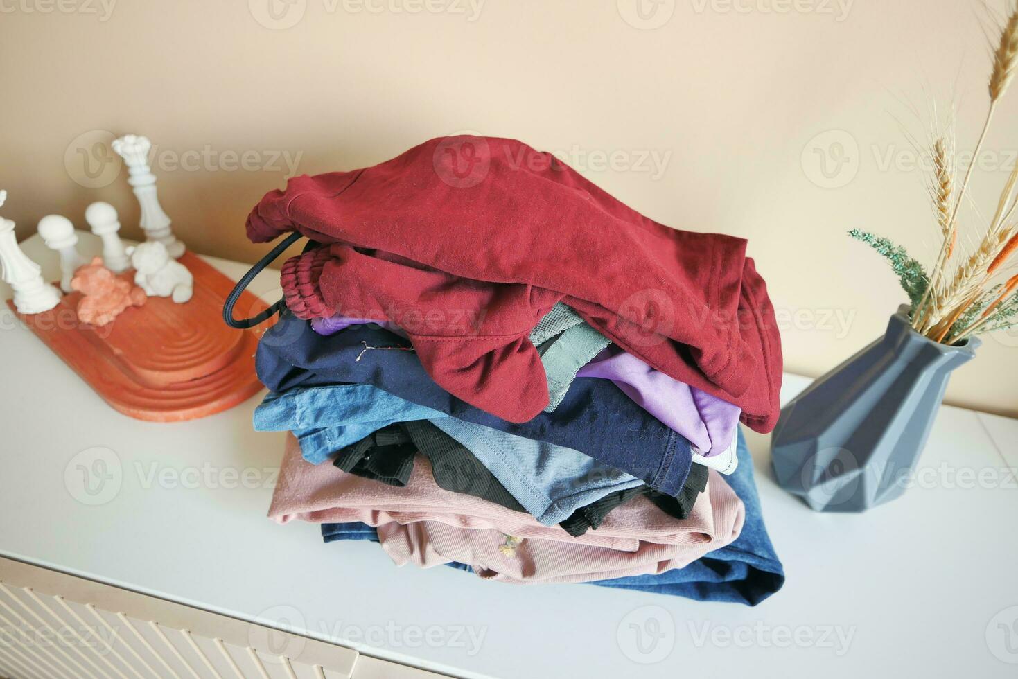 Stack of clothes on table indoor. photo