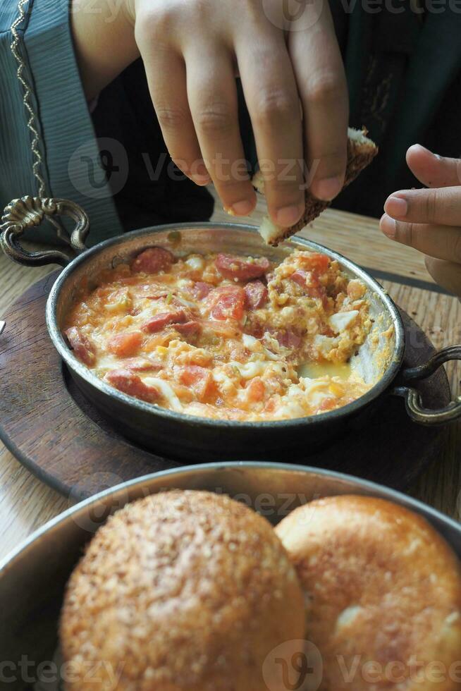 Turkish Menemen omelet in a frying pan. . photo