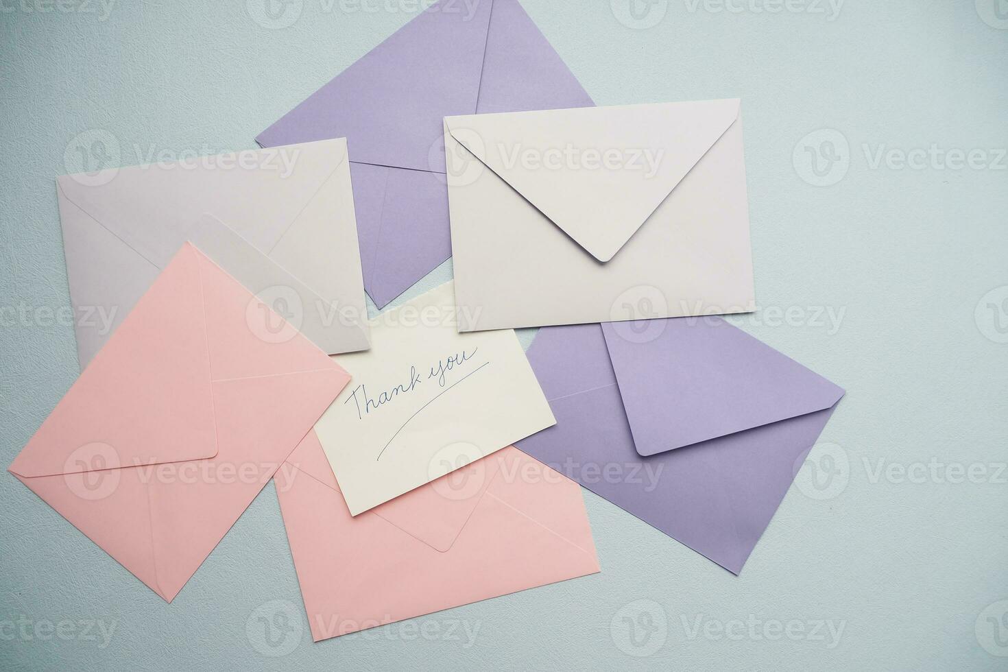 thank you message on colorful envelope on table photo