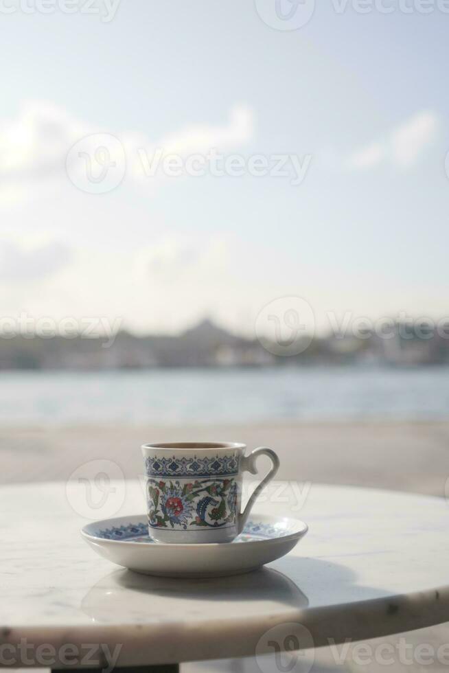 a cup of turkish coffee on table photo