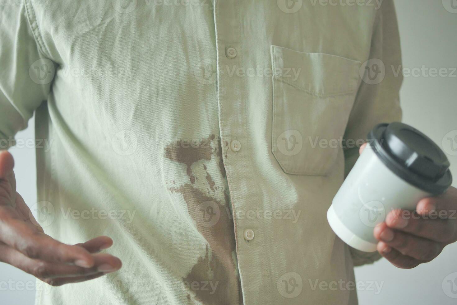 men hands with spilled coffee over his shirt photo