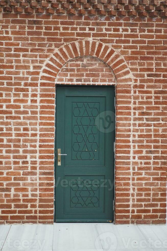 A large old green wooden door photo