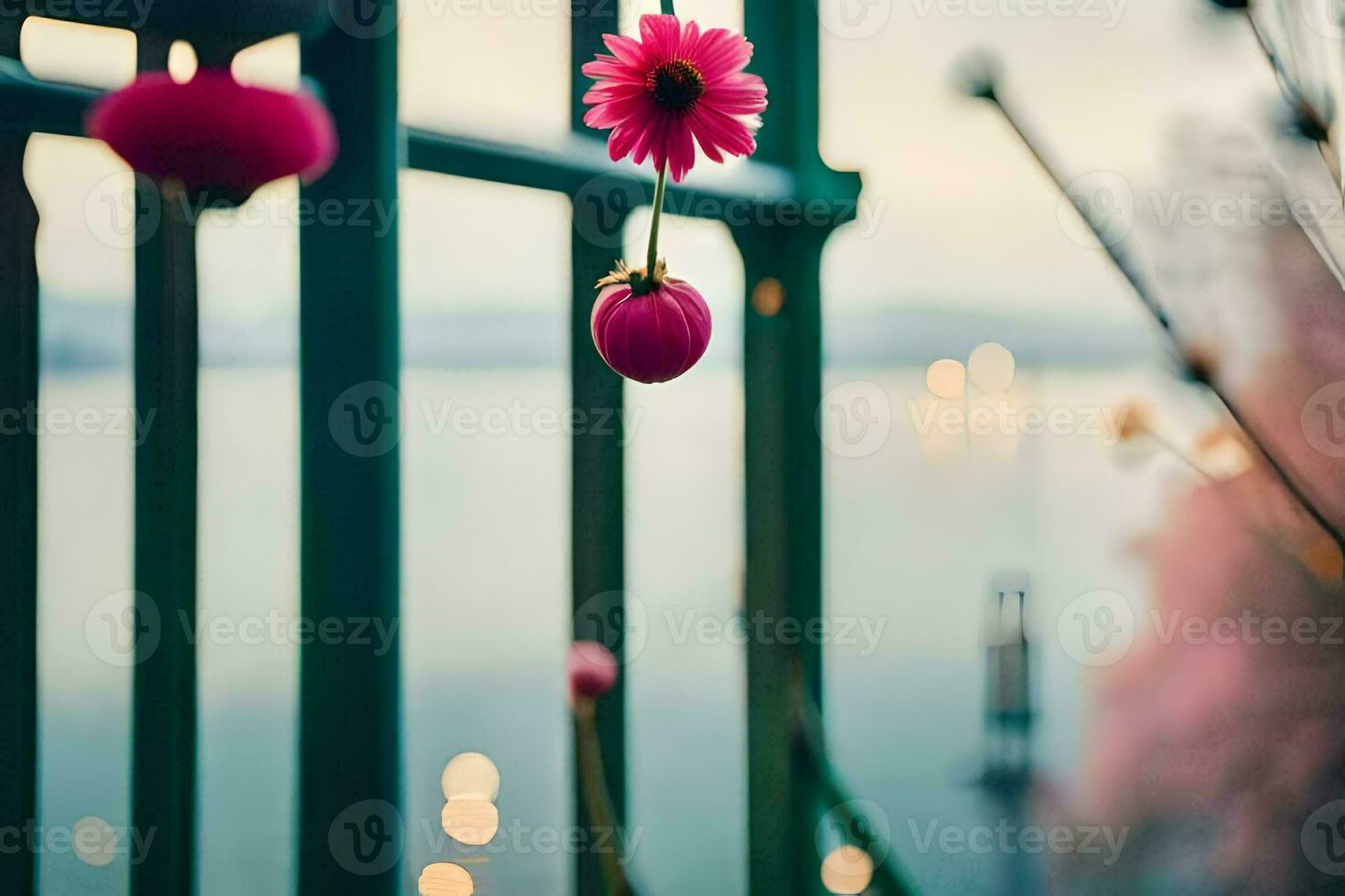 a pink flower is hanging from a fence. AI-Generated photo