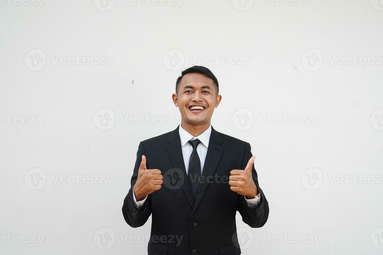 Portrait Young Asian businessman smiling happy face and thumb up, give praise, agree, isolated on white background photo
