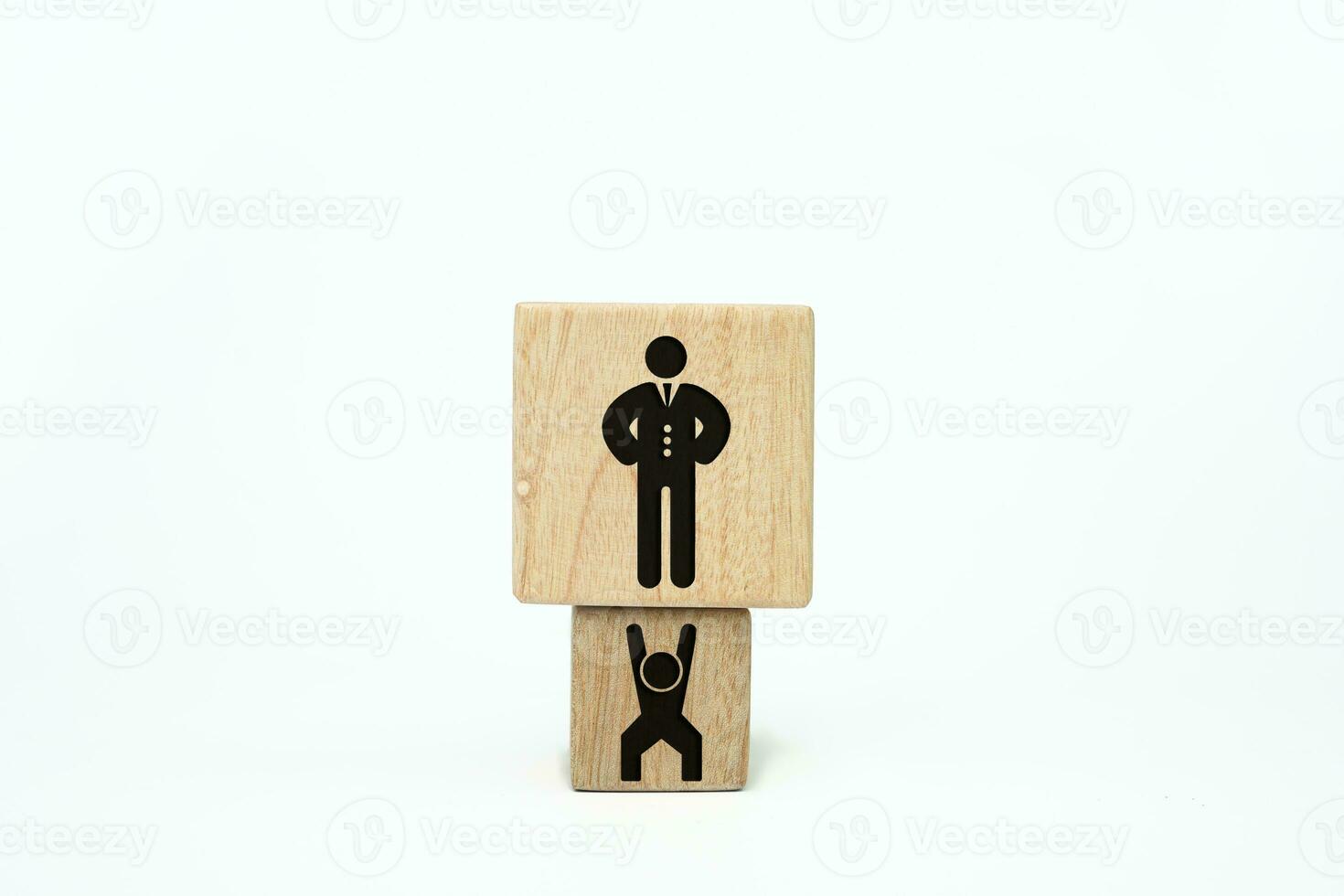 concept of employees working hard for the boss. Employees who work hard to make their boss richer. Wooden cube with a person icon take up a larger dice with a boss icon. Boss slave employee photo