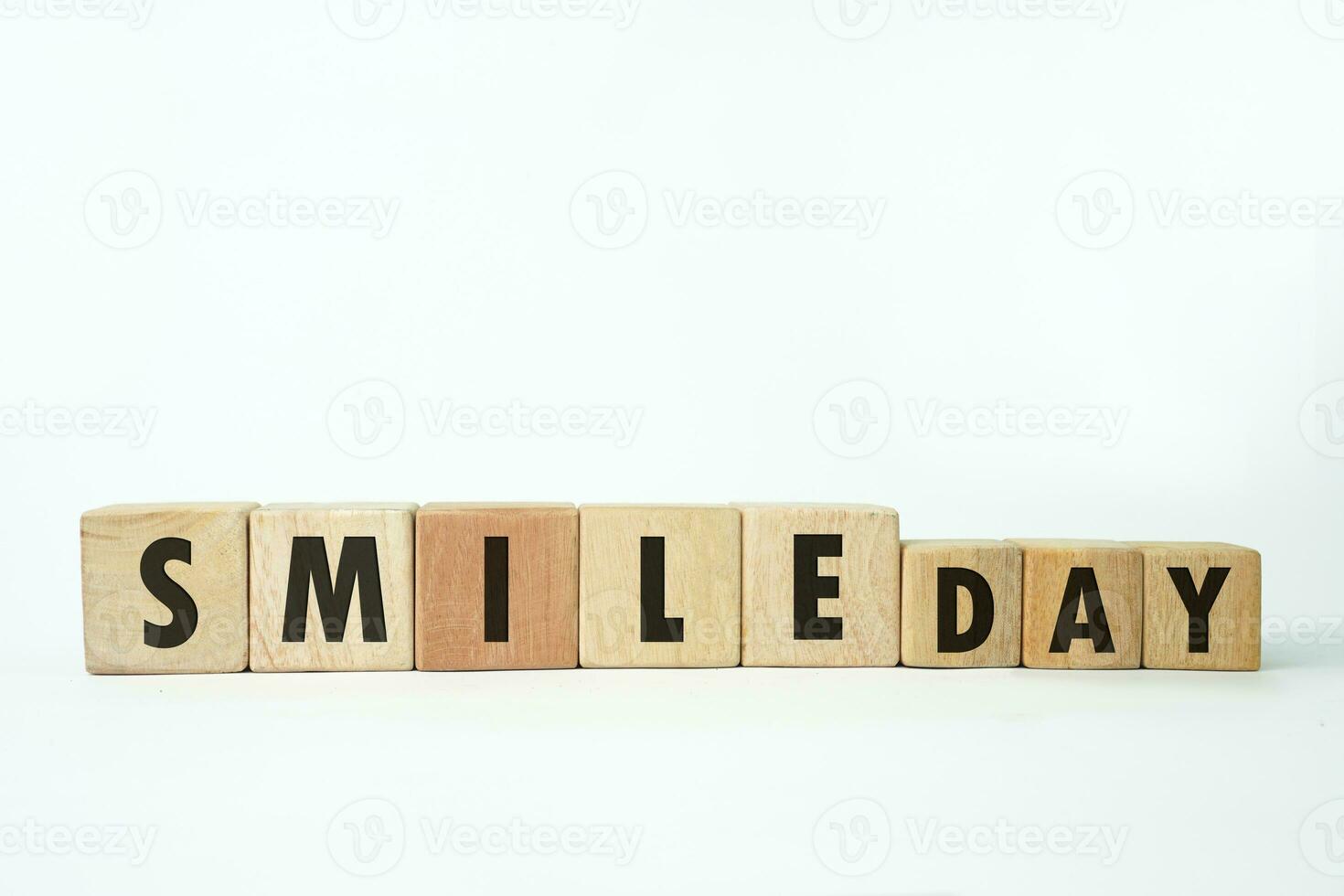 world smile day text on a wooden cube block shape with white background, October 6 photo