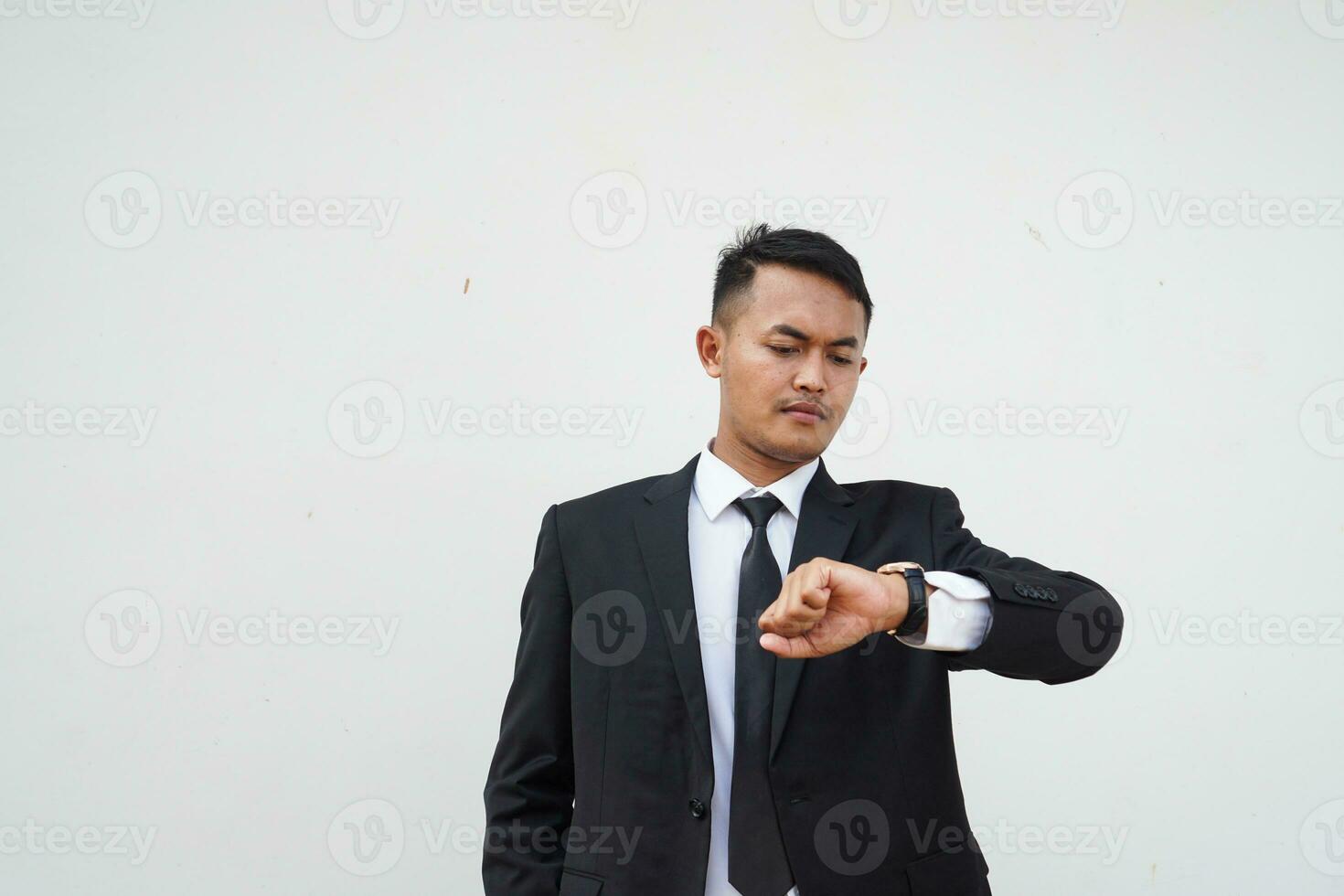 Portrait Young Asian businessman waiting gesture and look time at the watch , isolated on white background photo