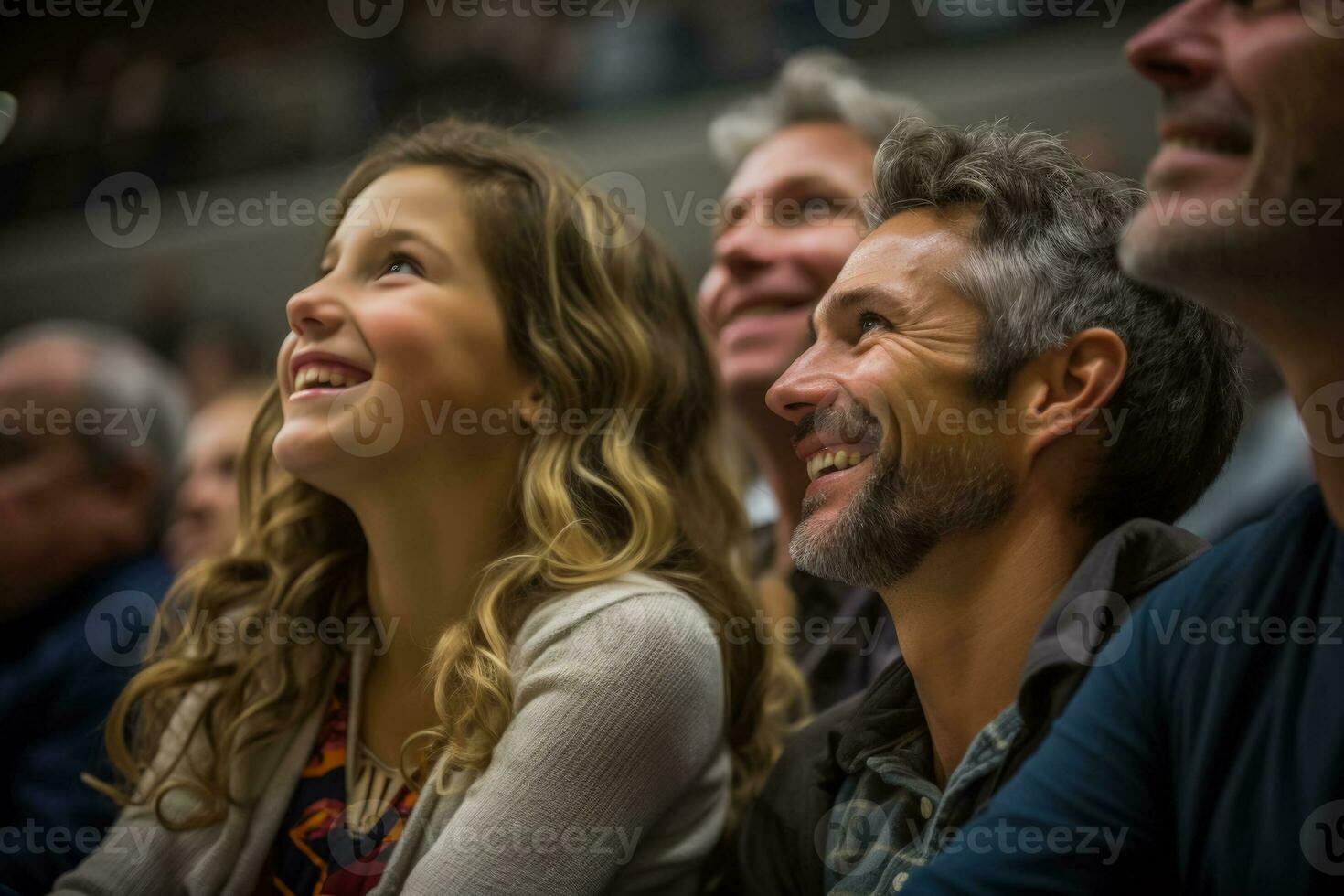 Parents proudly watching their children perform their faces filled with joy and admiration photo