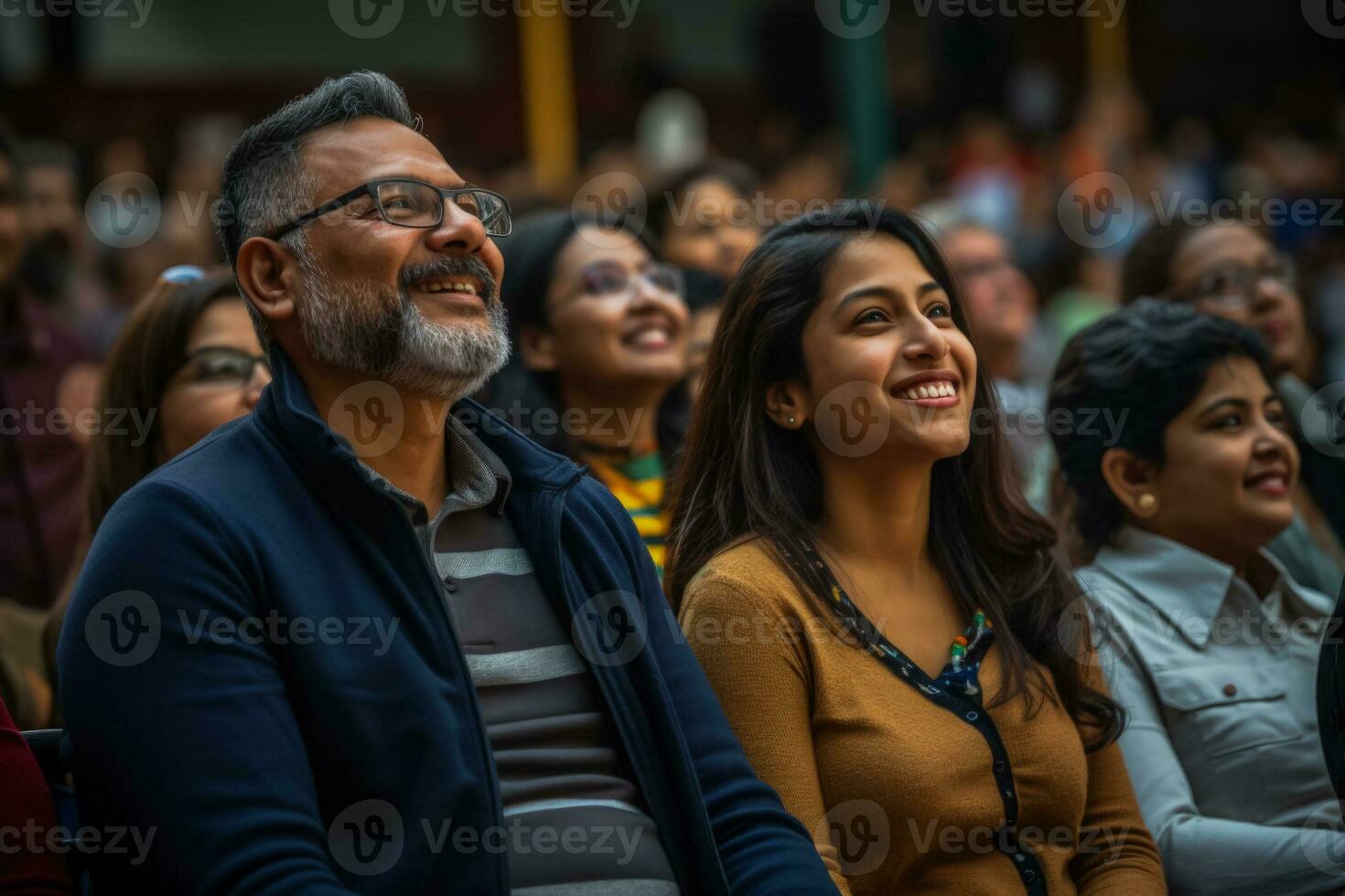 Parents proudly watching their children perform their faces filled with joy and admiration photo