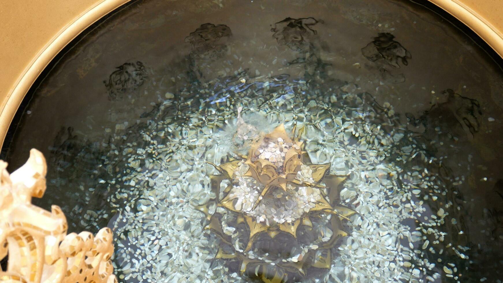 Sparkling coins at the bottom Water pond.Water holy pond which people and tourists are like to throw money coins into .Thailand's faith Believe get lucky good at Watrongkhun, chiang rai, THAILAND. photo