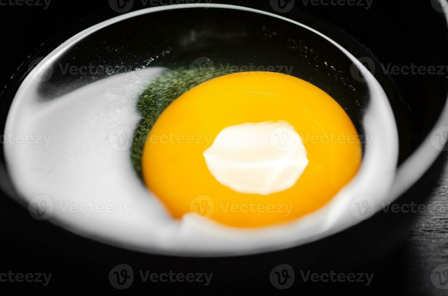 Chicken yolk from an egg in cup. photo