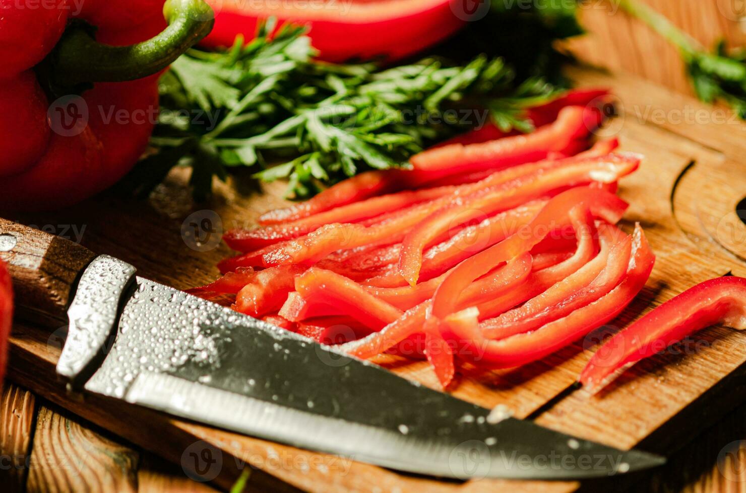 Chopped sweet pepper. On wooden table. photo