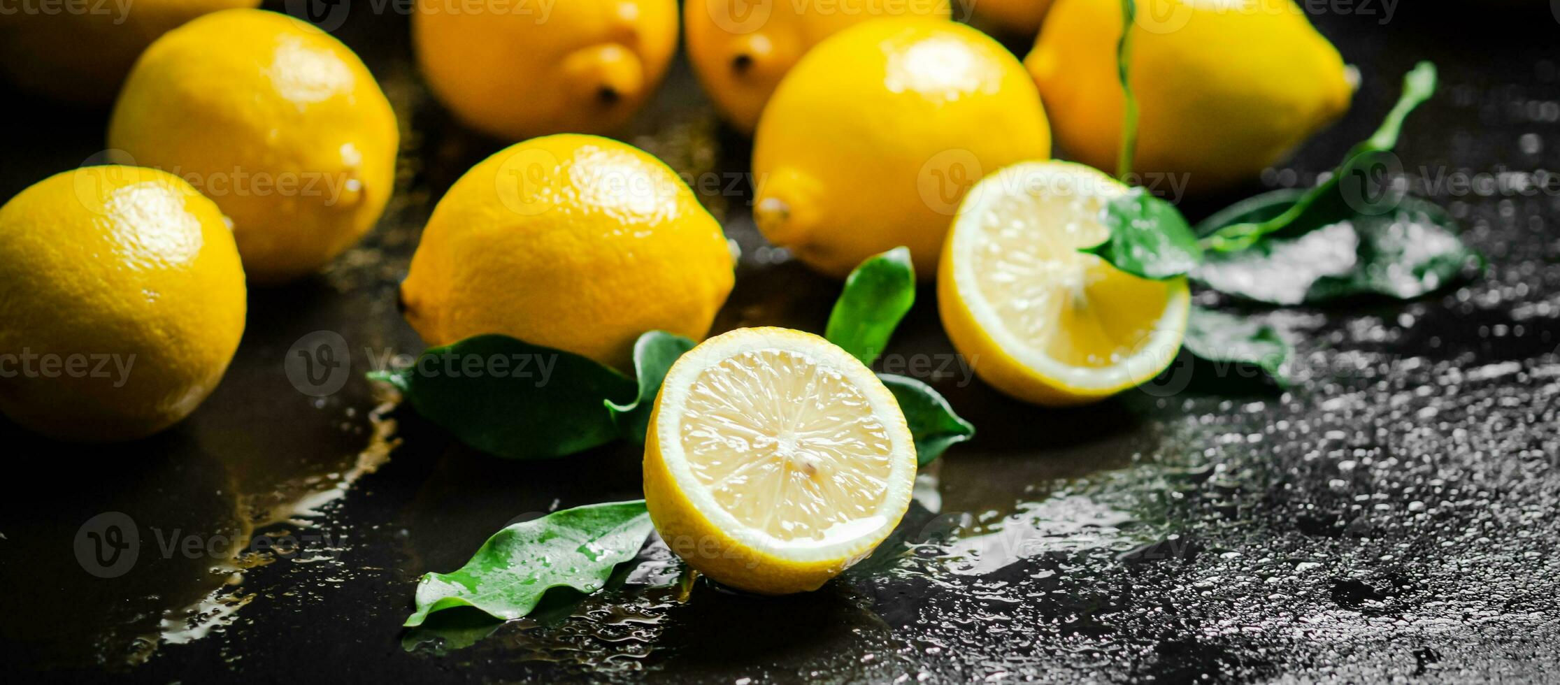 Fresh lemons. On black table. photo